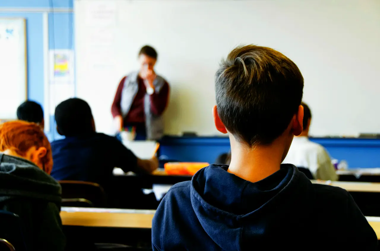 At the back of the class, someone listening