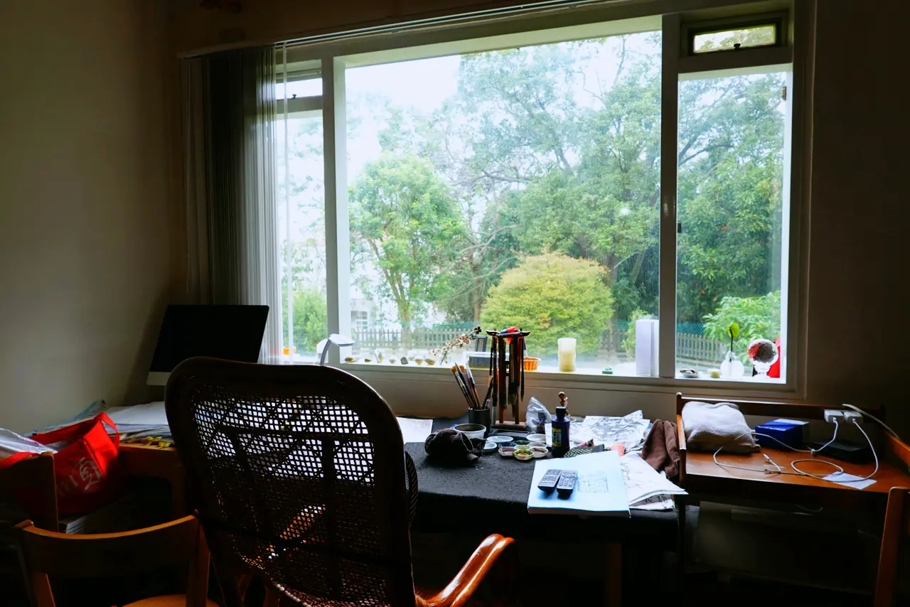 A desk by a large window