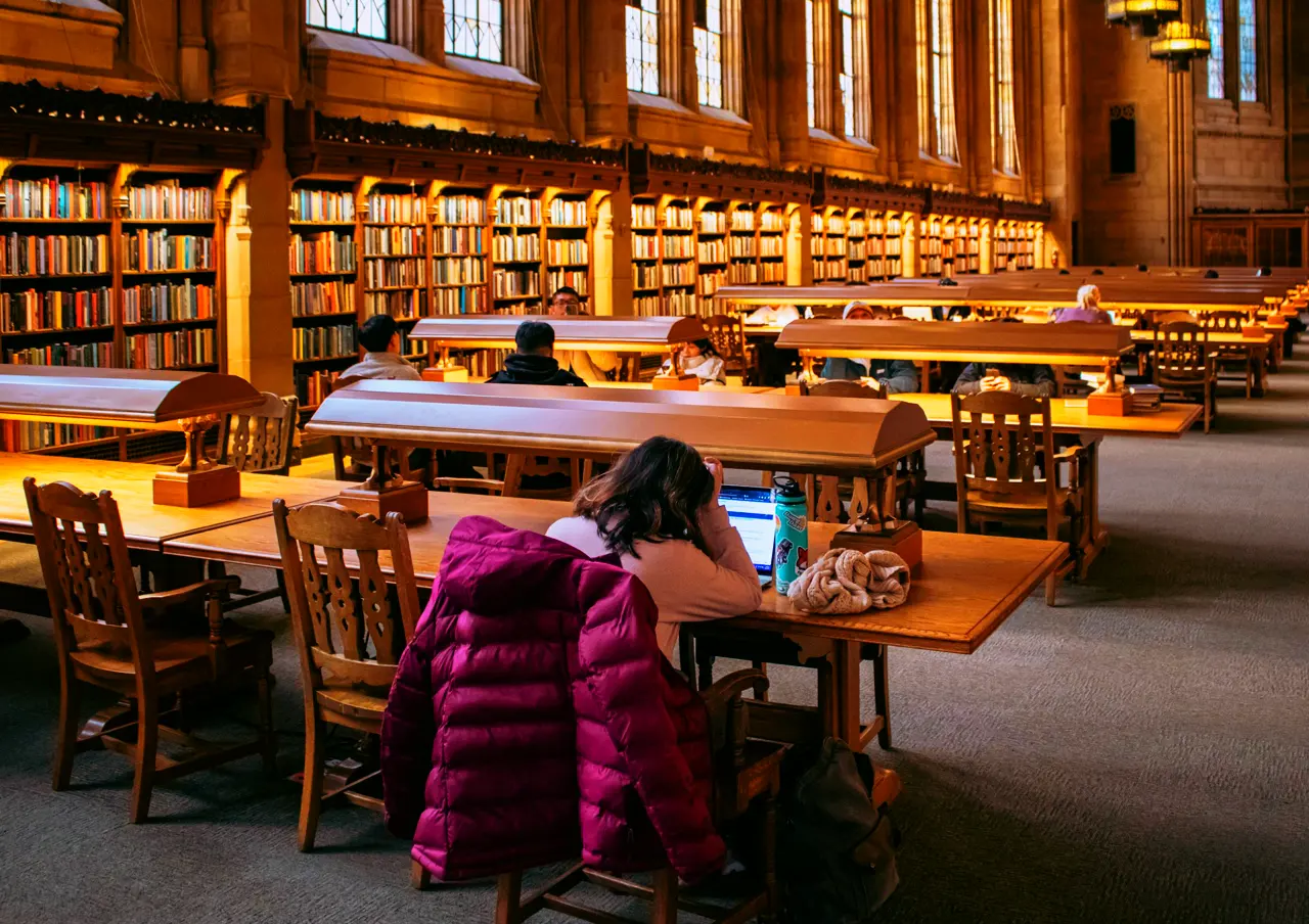 A large reading room with wooden tables