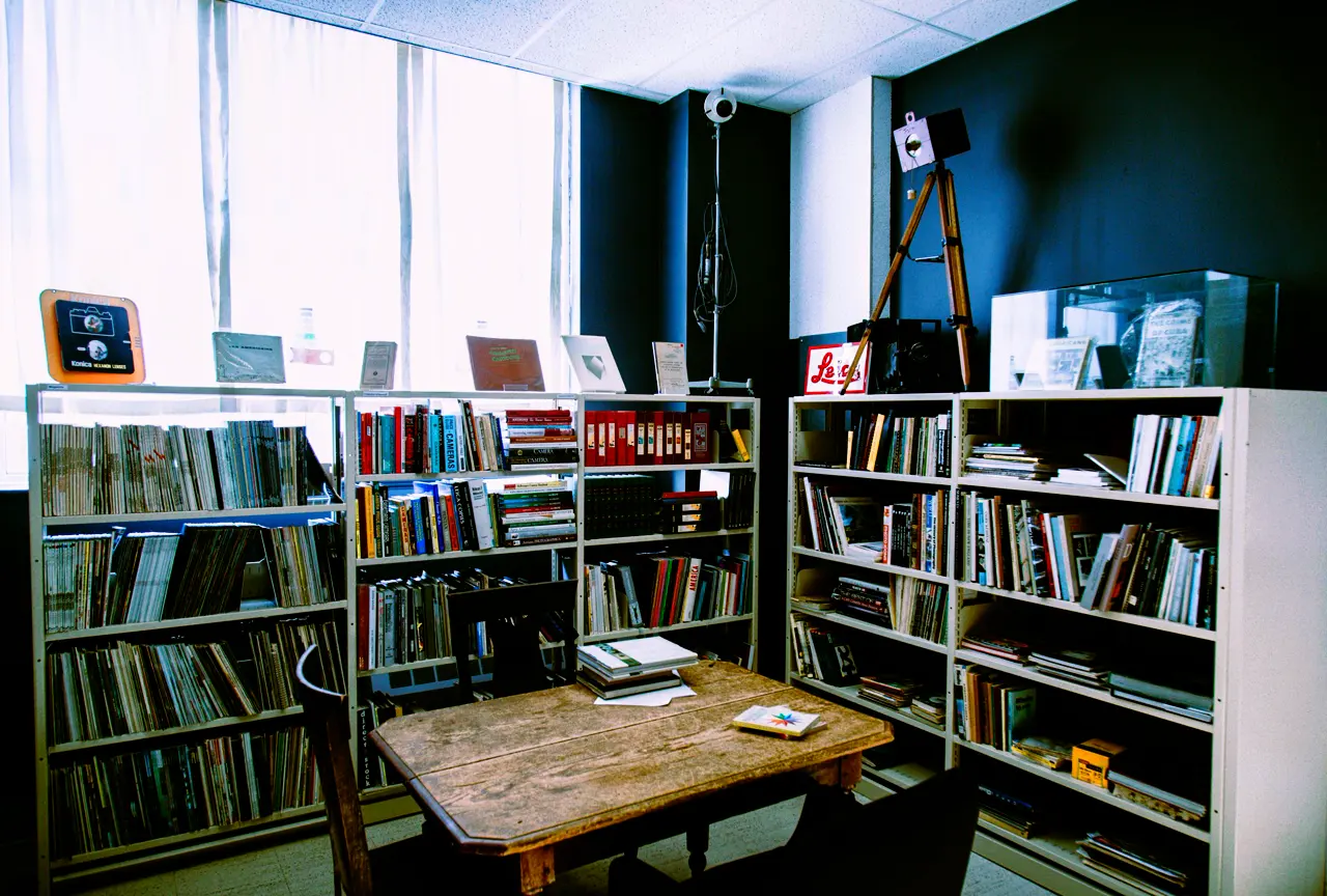A room with bookshelves and a wooden table