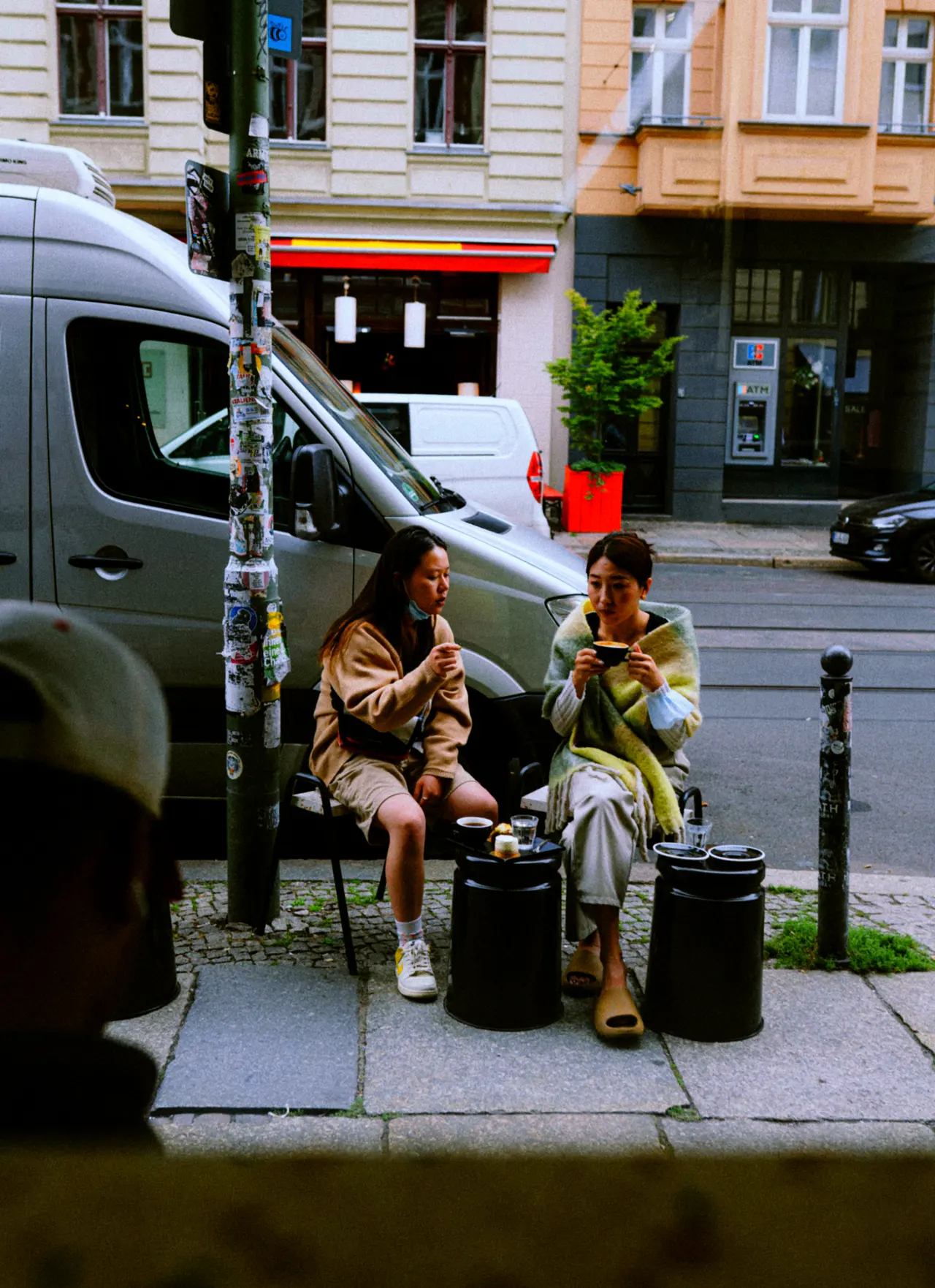 Two people on a bench in the street