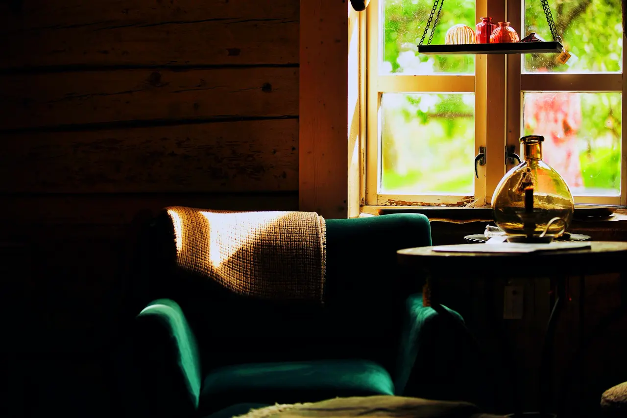 A chair and a small table by the window