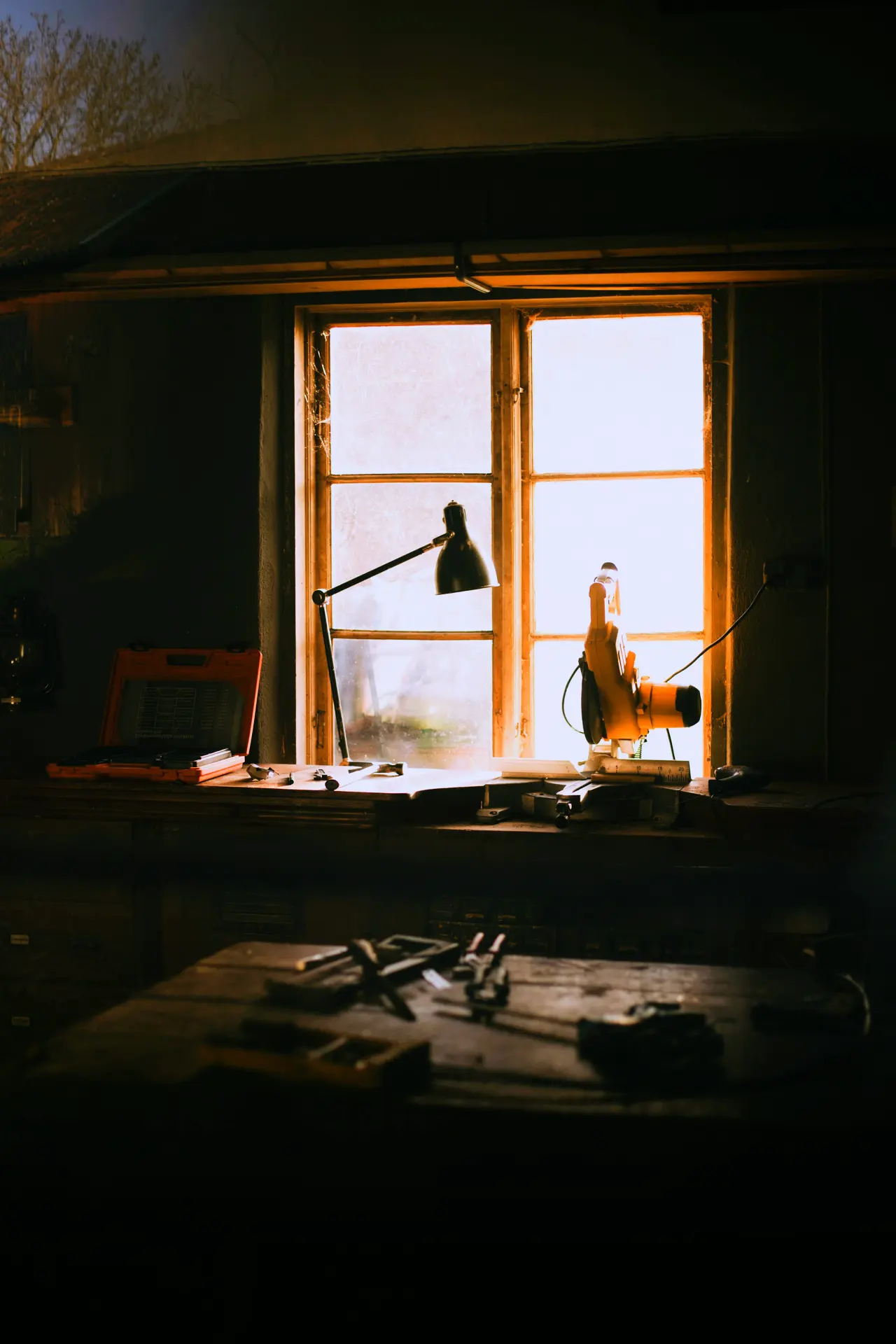 A workbench by the window, light from the side